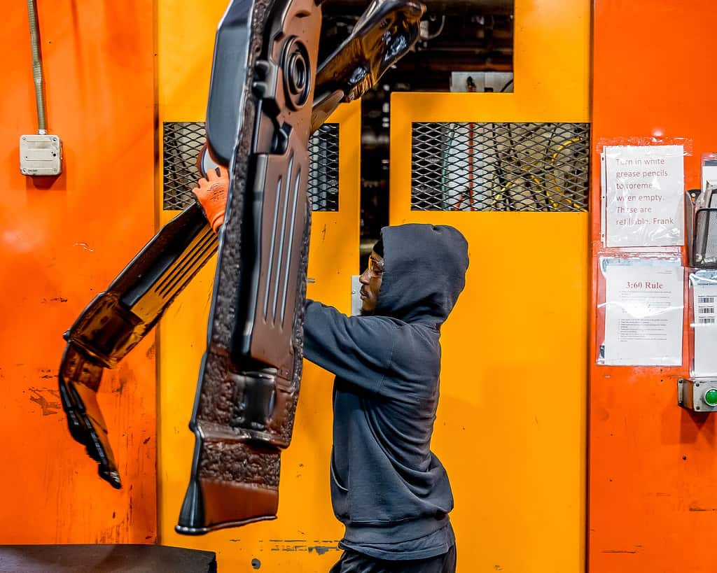 employee handling blow molded parts